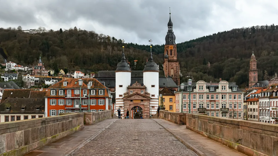 Arenisca roja bajo el cielo de noviembre: la entrada monumental a Heidelberg desde el río Neckar